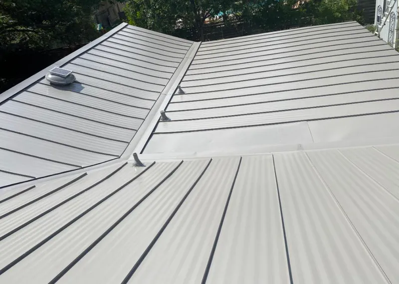 Solar attic fan installed on a metal roof for Roof Ventilation in Chelsea